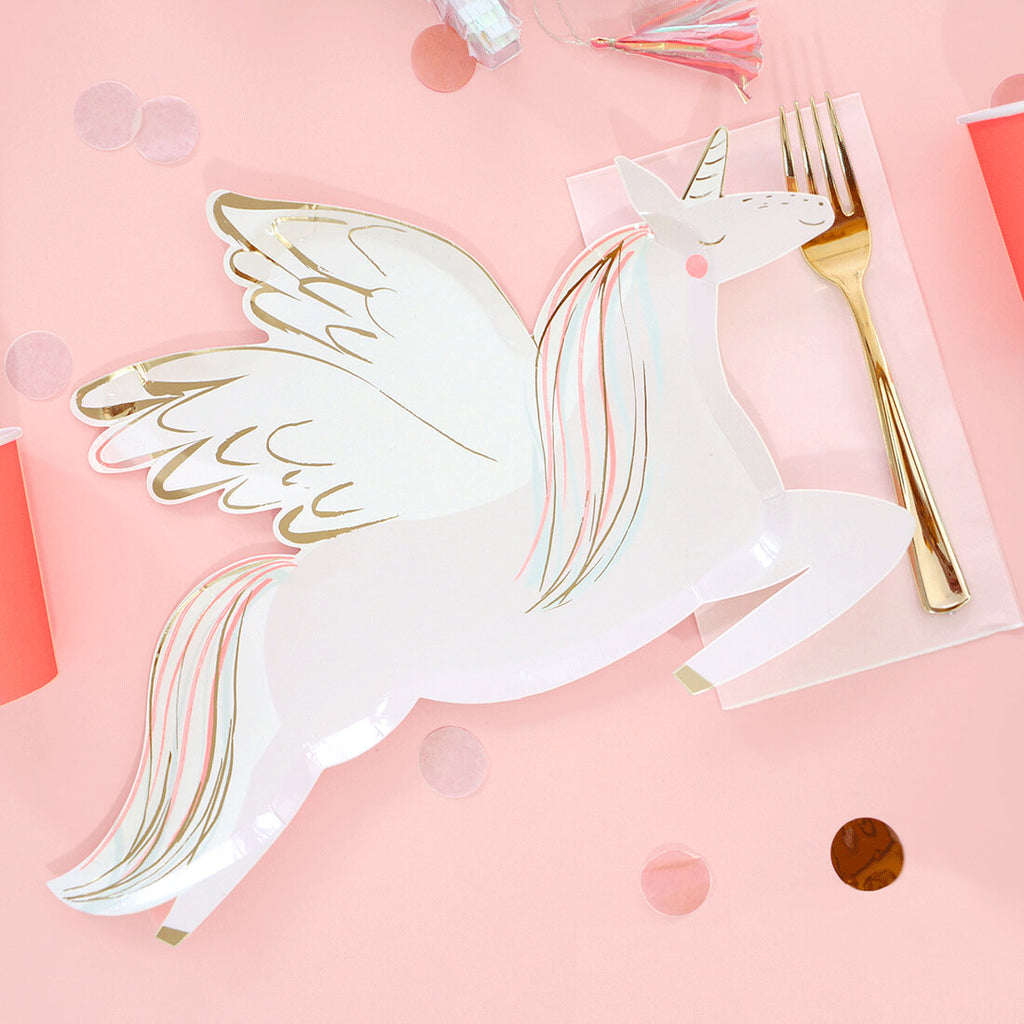 Meri-Meri-Winged-Unicorn-Birthday-Party-Plates-Table-Setting-On-Pink-Backdrop-With-Gold-Foil-Details